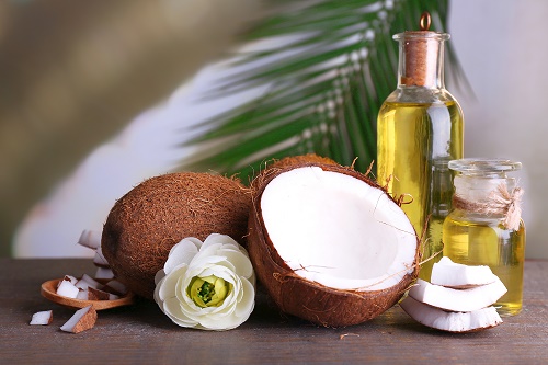 Coconuts and coconut oil on wooden table
